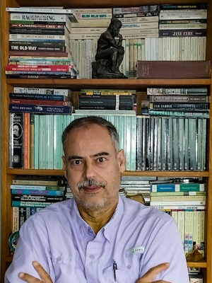 A monochrome photograph of the photographer in front of a couple of computer screens.